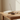 Wooden incense holder with a single incense stick on a white background